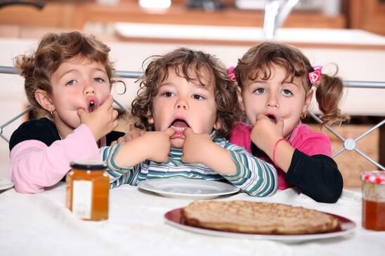 little kids eating pancakes